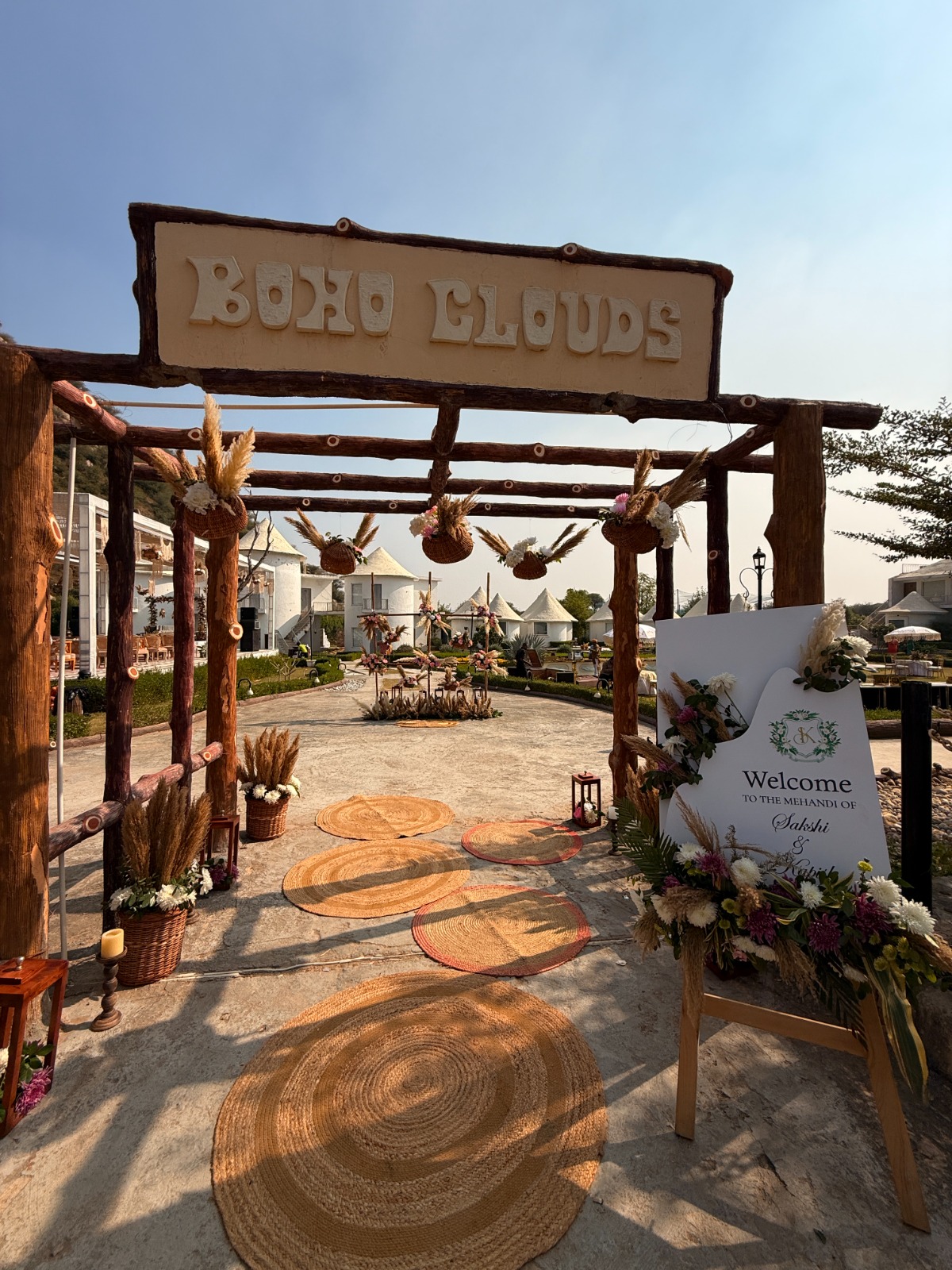 Boho-Mehendi-Entry-Decor-with-Wooden-Arch-Pampas-Grass-and-Welcome-Sign-Setup-04092026