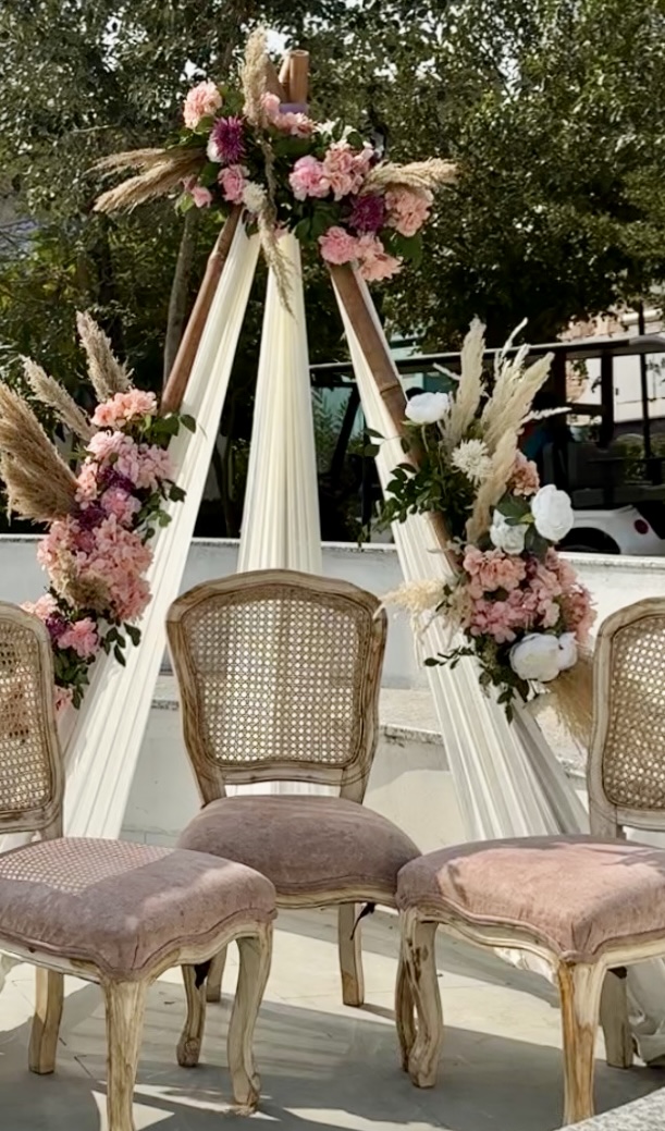 Boho-Mehendi-Sitting-Setup-with-Rattan-Chairs-and-Floral-Pampas-Backdrop-04092026