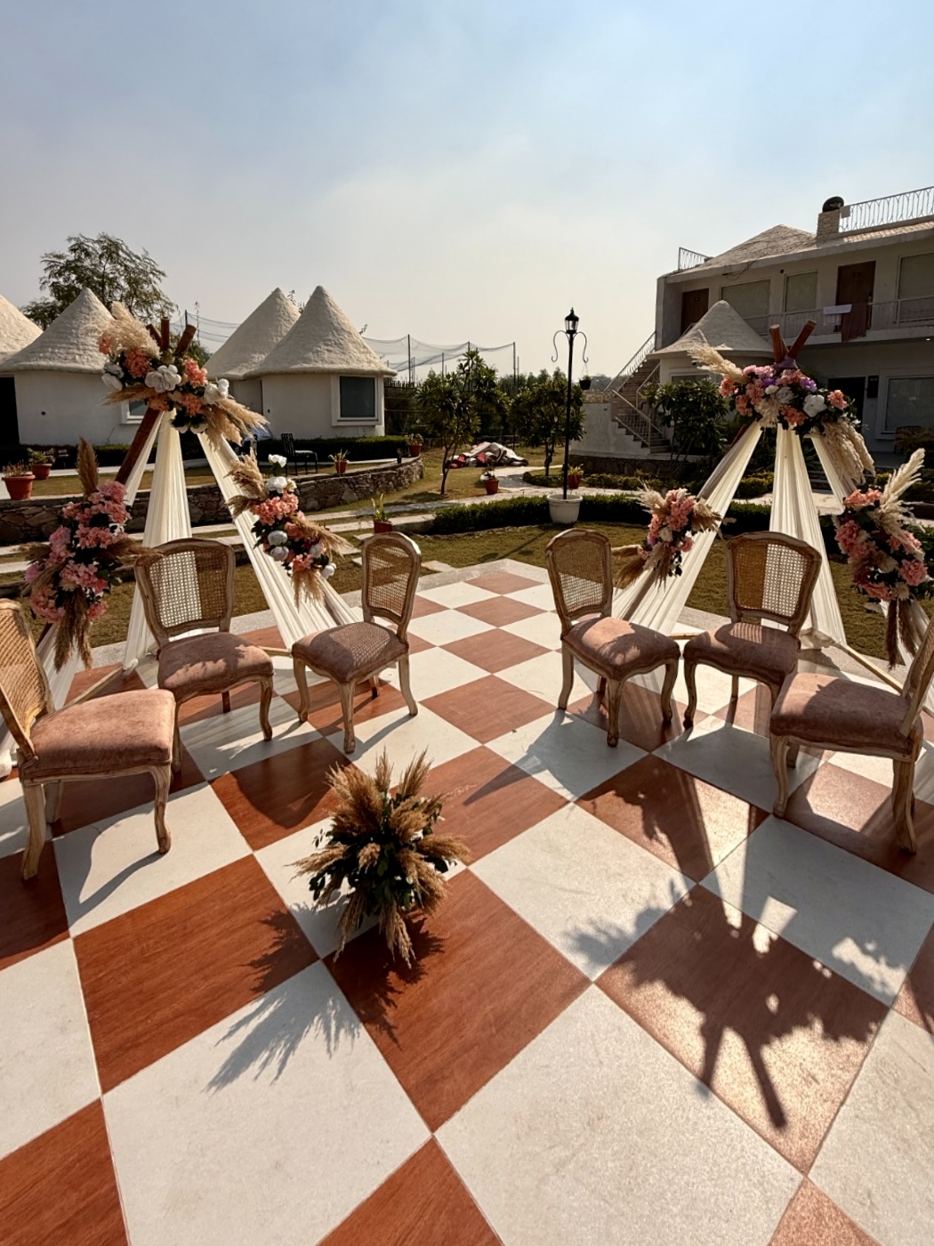 Boho-Mehendi-Sitting-Setup-with-Rattan-Chairs-and-Floral-Pampas-Backdrop-Outdoor-04092026