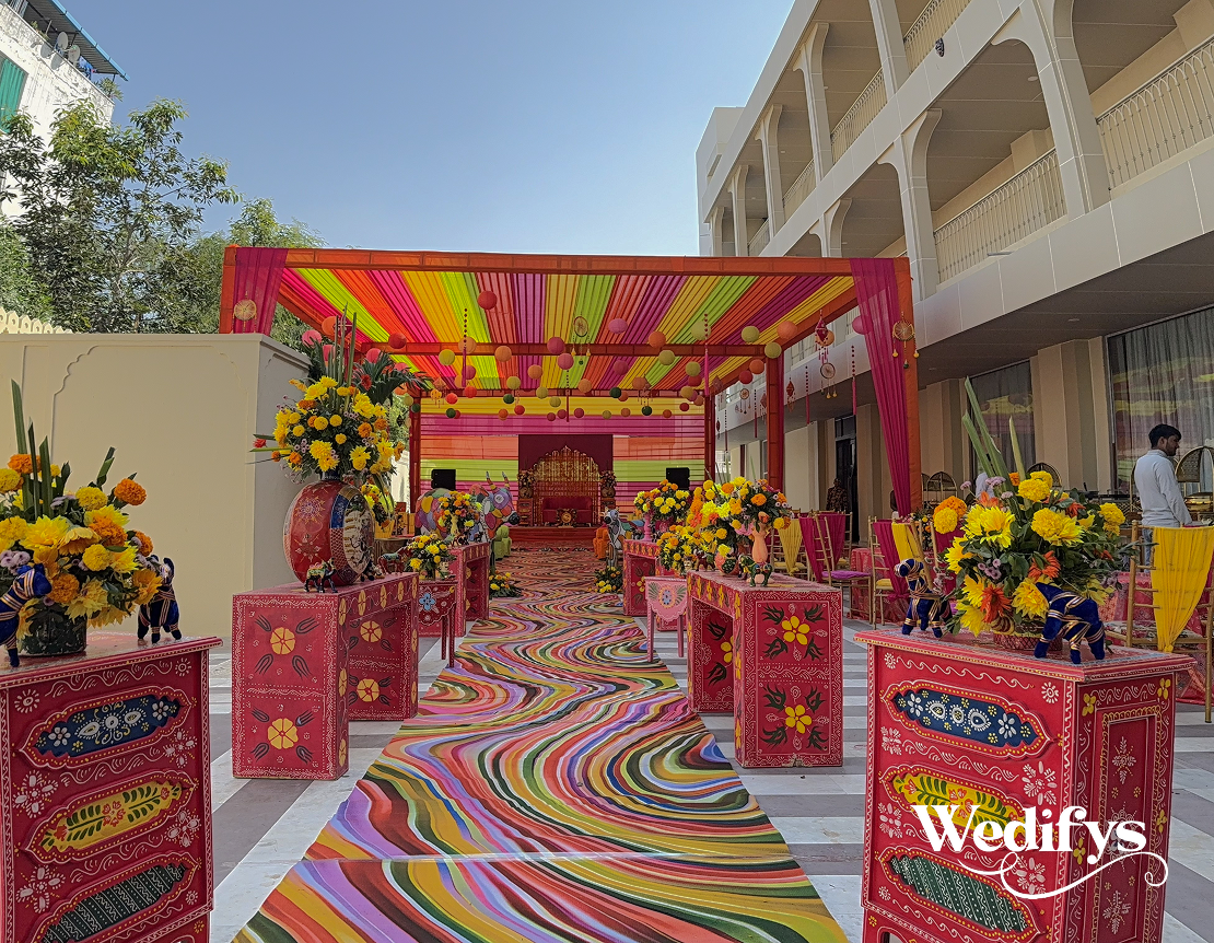 Colorful-Haldi-Walkway-Decor-with-Rainbow-Carpet-and-Vibrant-Canopy-Setup-04242026