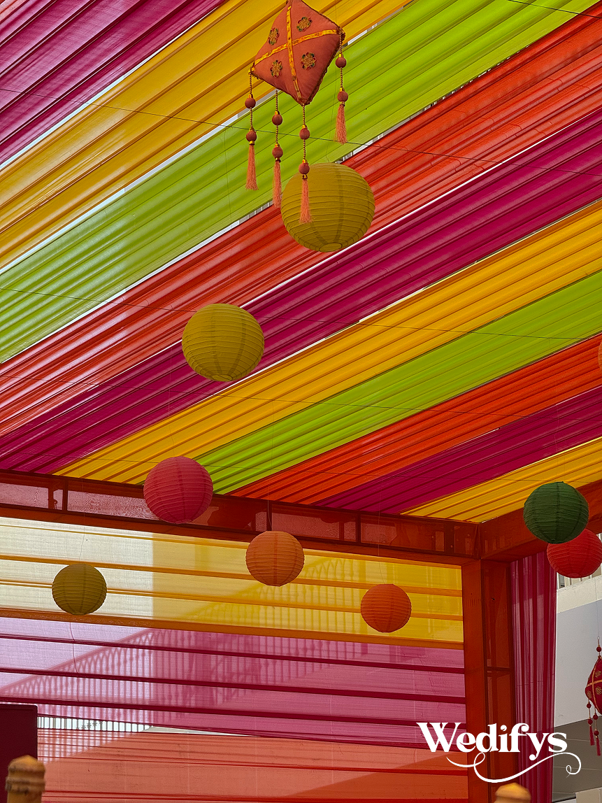 Haldi-Canopy-Decor-with-Colorful-Drapes-and-Hanging-Lanterns-04242026