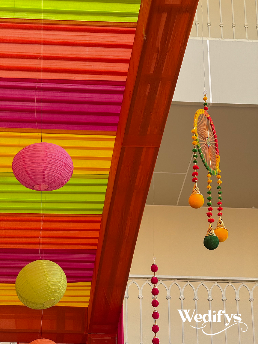Haldi-Canopy-Edge-Decor-with-Colorful-Drapes-and-Hanging-Lanterns-04242026