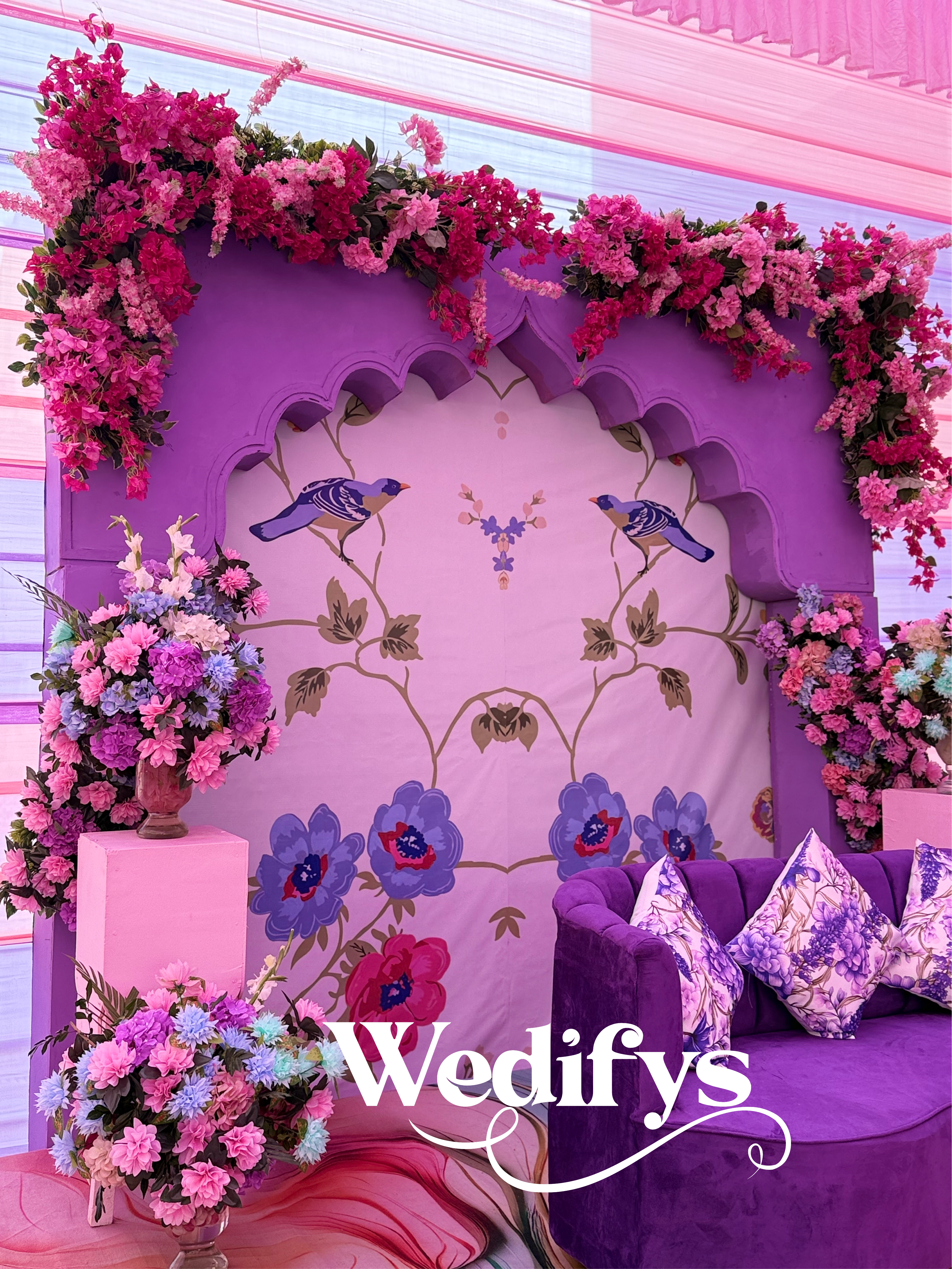 Lilac-and-Pink-Haldi-Stage-Decor-with-Floral-Arch-and-Artistic-Backdrop-04132026