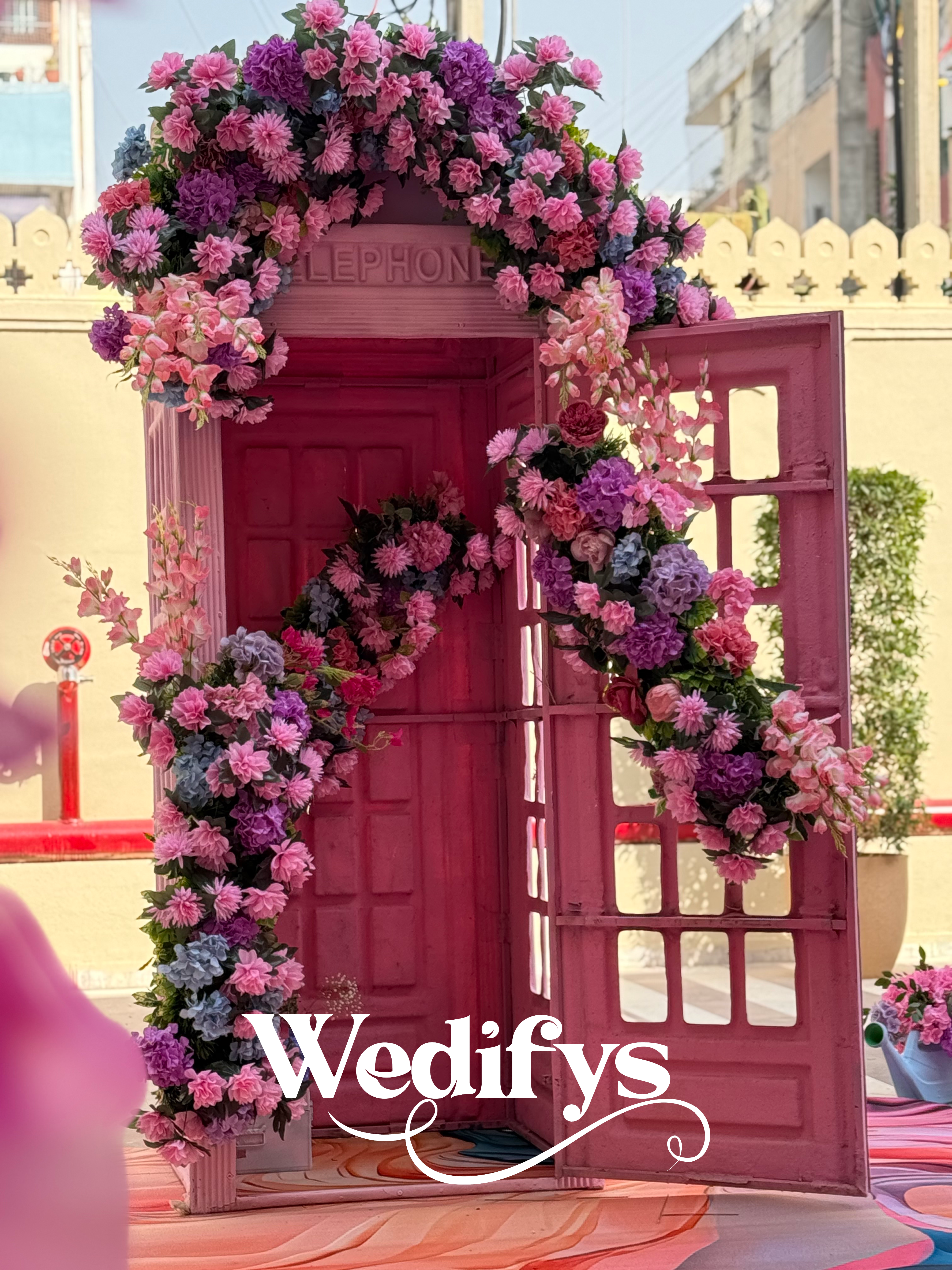 Pastel-Pink-Haldi-Entry-Decor-with-Floral-Phone-Booth-Setup-04132026