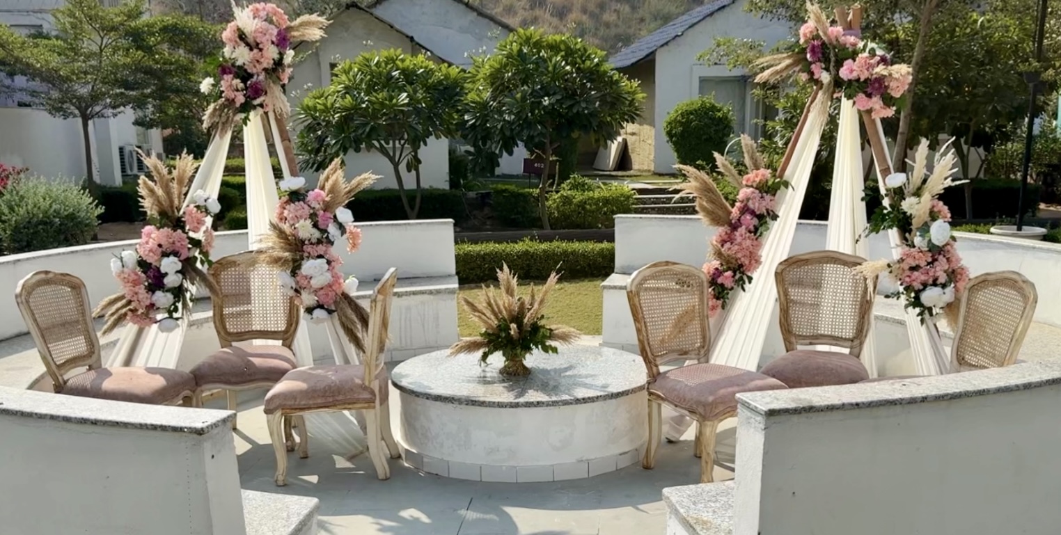 Symmetrical-Boho-Mehendi-Sitting-Setup-with-Floral-Frames-and-Rattan-Chairs-04092026